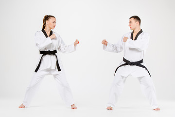 Image showing The karate girl and boy with black belts