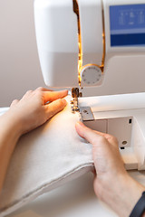 Image showing Seamstress working at sewing machine