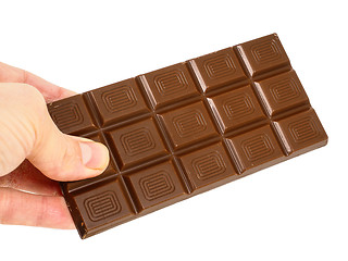 Image showing Person holding a whole bar of light chocolate isolated towards w