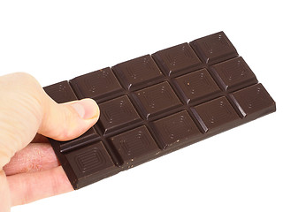 Image showing Person holding a whole bar of dark chocolate isolated towards wh