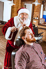 Image showing Santa claus as master at barber shop