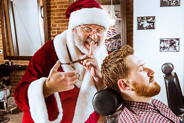 Image showing Santa claus as master at barber shop