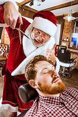 Image showing Santa claus as master at barber shop