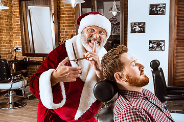 Image showing Santa claus as master at barber shop