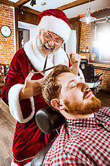 Image showing Santa claus as master at barber shop