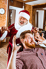 Image showing Santa claus as master at barber shop