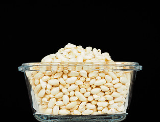 Image showing Puffed rice in translucent square glass bowl, towards black