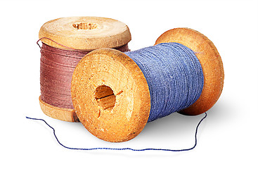 Image showing Two different colored thread on wooden spools