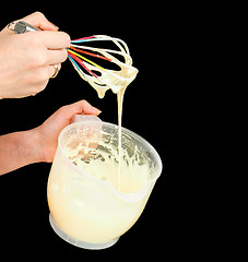 Image showing Female person making Gogl-Mogl, with hand whisker in plastic bow