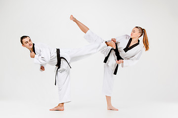 Image showing The karate girl and boy with black belts