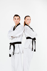 Image showing The karate girl and boy with black belts