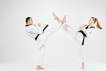 Image showing The karate girl and boy with black belts