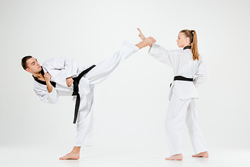 Image showing The karate girl and boy with black belts