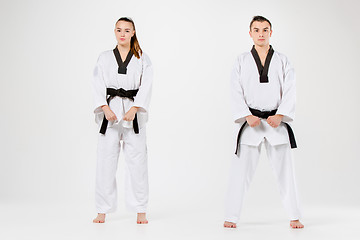 Image showing The karate girl and boy with black belts