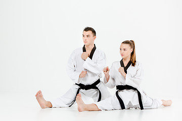 Image showing The karate girl and boy with black belts