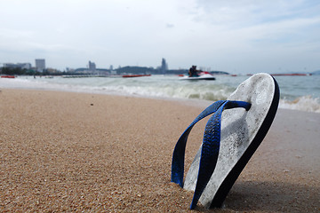 Image showing Beach slippers on a sandy beach