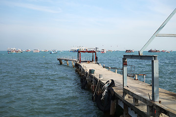 Image showing Walkway to pier among blue sea and clear sky