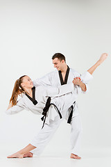 Image showing The karate girl and boy with black belts