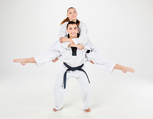 Image showing The karate girl and boy with black belts