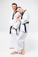 Image showing The karate girl and boy with black belts