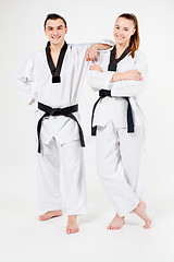 Image showing The karate girl and boy with black belts