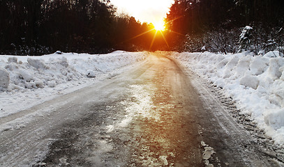 Image showing winter road and forest at sunset