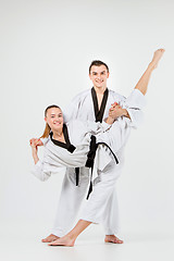 Image showing The karate girl and boy with black belts