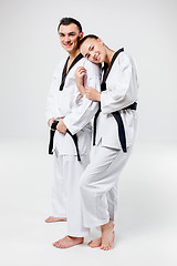 Image showing The karate girl and boy with black belts