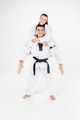 Image showing The karate girl and boy with black belts