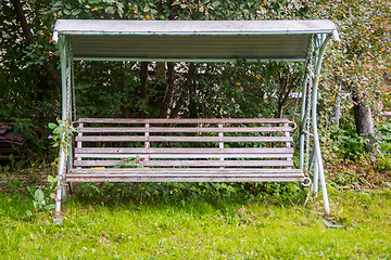 Image showing Old swing bench in old apple orchard