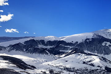 Image showing Winter snow mountains and village at sun morning