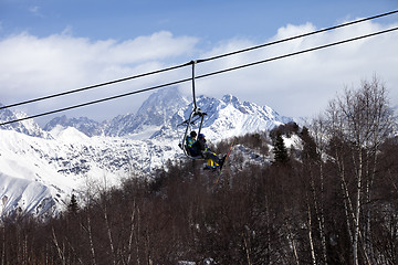 Image showing Father and daughter on ski-lift at nice sun day