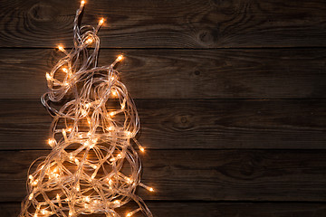 Image showing Glowing festoon on brown background,