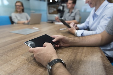 Image showing close up of businessman on meeting using tablet