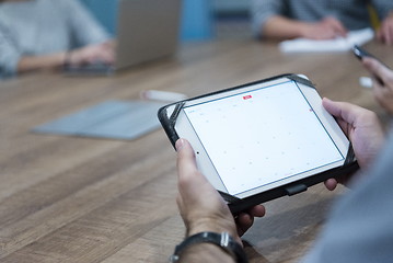 Image showing close up of businessman on meeting using tablet