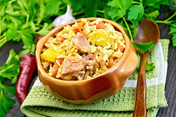 Image showing Rice with chicken and zucchini in bowl on dark board