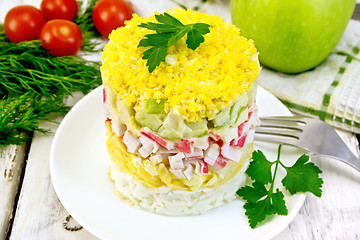 Image showing Salad of crab sticks and apple on board