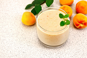 Image showing Milkshake apricot with mint on granite table