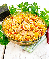 Image showing Rice with chicken and zucchini in glass pan on board