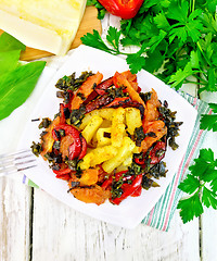 Image showing Courgettes with vegetables in plate on board top