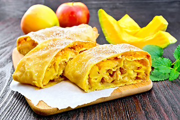 Image showing Strudel pumpkin and apple on dark board