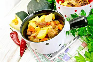 Image showing Roast meat and vegetables in white pots on board