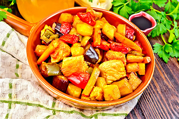 Image showing Roast with vegetables and honey in pan on board