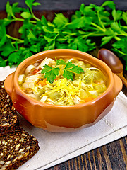 Image showing Soup Minestrone in clay bowl on dark board