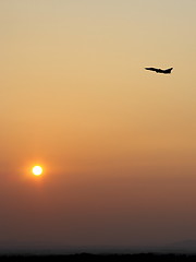 Image showing Airplane in the sky at sunrise