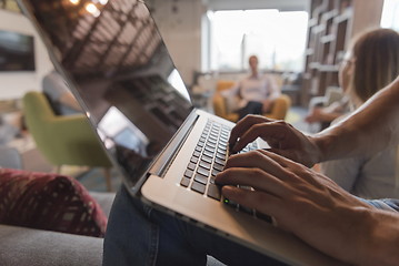 Image showing close up of male hands while working on laptop