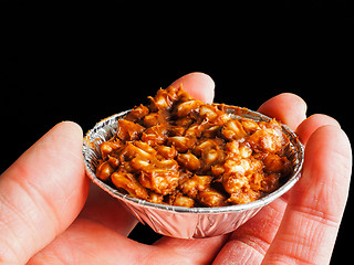 Image showing Person holding puffed rice with chocolate cake in aluminum cup, 