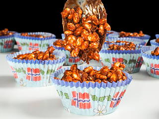 Image showing Puffed rice chocolate cup cakes being filled, on white table tow