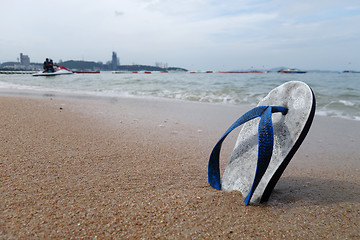 Image showing Beach slippers on a sandy beach