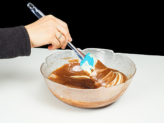 Image showing Female person blending chocolate gently with Gogl-Mogl, in a gla